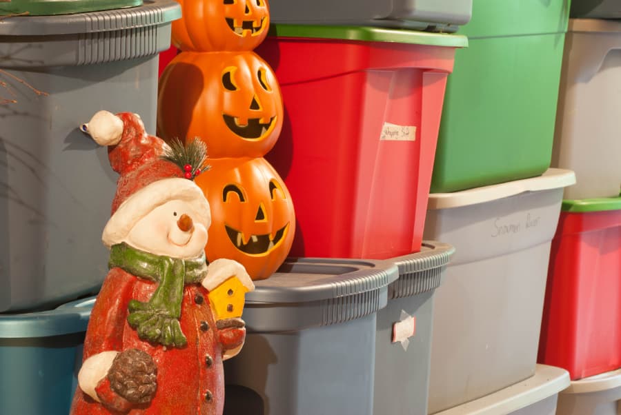 Holiday decorations in bins in storage unit