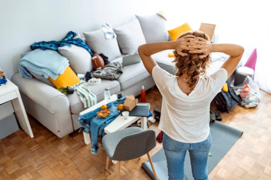 Stressed person at home looking at messy room