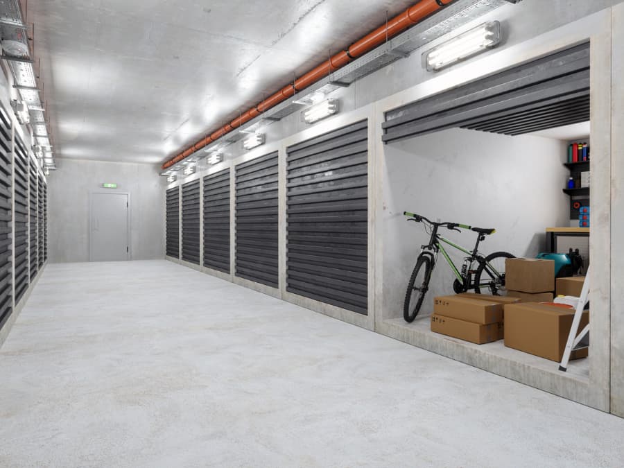 Well-lit storage unit with boxes and bicycle